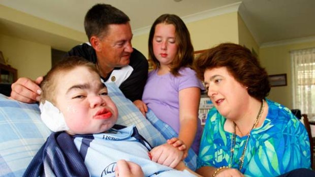 Final comfort ... Sandra and Phillip Brown with their ailing son Ben, who has a degenerative genetic disorder, and their daughter Stephanie at their Cranebrook home.