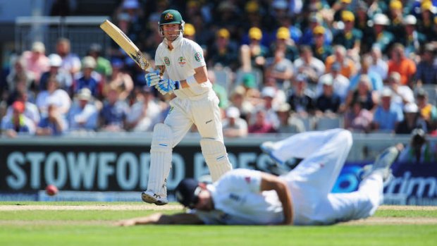 Captain's knock: Michael Clarke beats his diving England counterpart Alastair Cook on his way to 187 in Australia's first innings at Old Trafford.