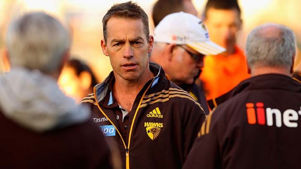 Alastair Clarkson leaves after speaking to his players during a break.