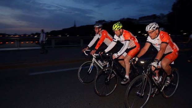Prime Minister Tony Abbott ride his bike through a pre-dawn Paris with the Australian military service charity Mates 4 Mates in France on Saturday 7 June May 2014.