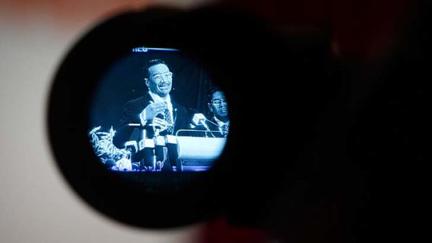 Life through a lens: Hishammuddin Hussein is filmed during a press conference.