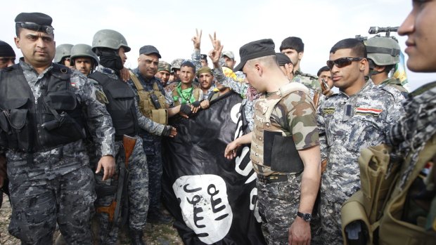 An Islamic State flag captured by Iraqi police and Shiite fighters earlier this month. 