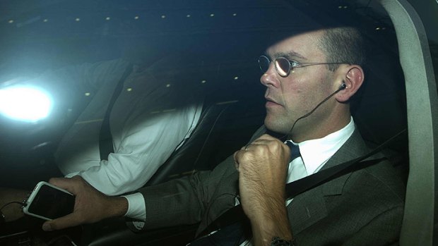 Standing down... James Murdoch is driven away from the offices of News International in London.