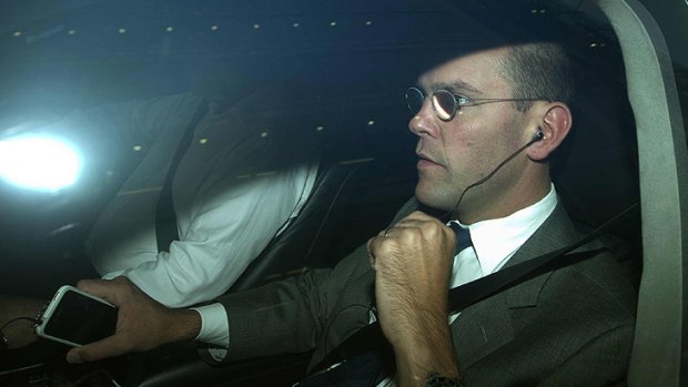 James Murdoch is driven away from the offices of News International in London overnight.