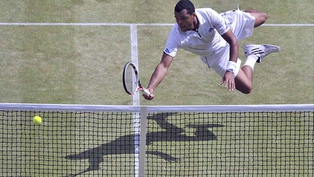 Jo-Wilfried Tsonga of France dives to hit a return to Novak Djokovic of Serbia during their semi-final match at the Wimbledon tennis championships in London July 1, 2011.               REUTERS/Carl de Souza/Pool     (BRITAIN  - Tags: SPORT TENNIS)