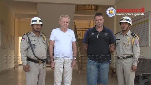 Victorian man Guido James Eglitis (left) and another foreign suspect under arrest in the Cambodian town of Siem Reap.
