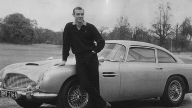 Sean Connery, as James Bond, with an Aston Martin DB5.