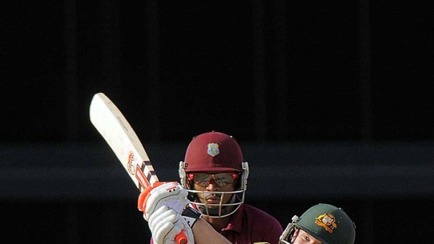 David Warner hits a six off West Indies spinner Sunil Narine. His run-out was the turning point in Australia's innings.