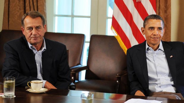 US President Barack Obama speaks with US Speaker of the House John Boehner.