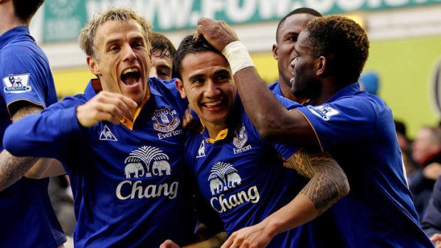 Tim Cahill (c) celebrates a goal with Everton teammates