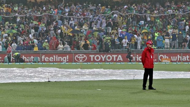 One way to stay amused ... fans who attended Sunday's one-day international between Australia and Sri Lanka soaked up the rain delay by making a giant snake from empty beer cups. The match was later called off due to wet weather.