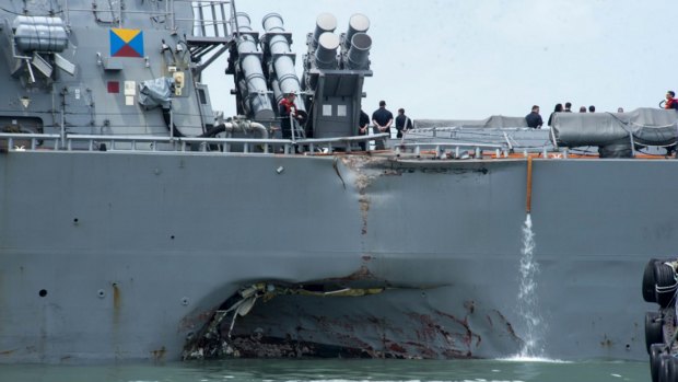 Damage to the portside of the USS John S. McCain is visible.