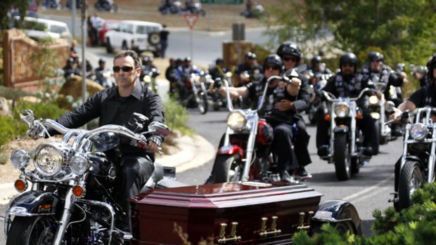Rebels gang bikies  roar through Canberra at the funeral of  Richard John Roberts, who was shot dead in the capital  last week.