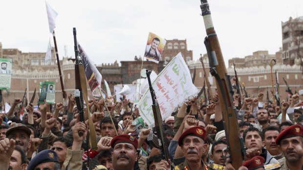 Houthi rebels hold up their weapons to protest against Saudi-led air strikes during a rally in Sana'a last week.