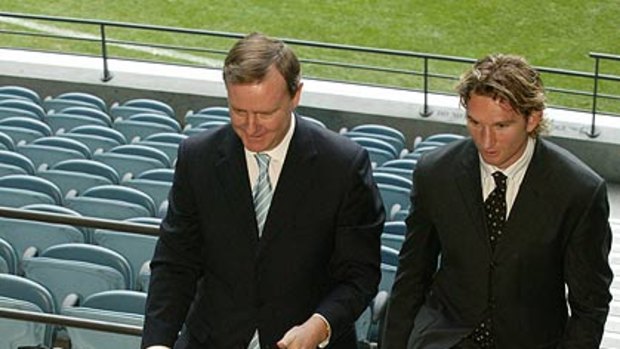 Peter Costello with Essendon great James Hird.