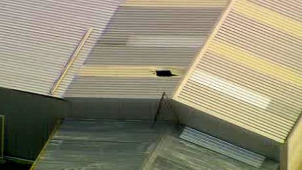 Man, 52, was fixing a roof on a friend's garage when he fell through perspex sheeting. Photo: Channel Ten