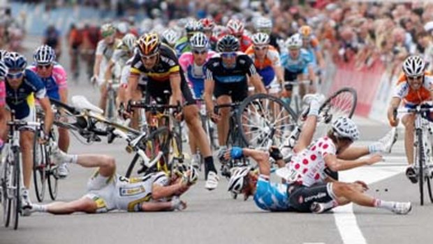 Painful end ... Heinrich Haussler, white with red polka dots, comes down hard amid the carnage caused by Mark Cavendish, left.