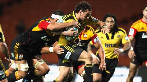 Aaron Cruden of the Hurricanes tries to break through the Chiefs' defence.