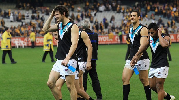 Port Adelaide players leave the field after their team's 165 point loss to Hawthorn at the MCG this month.