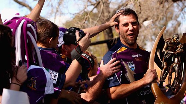 Smiling for the cameras ... Melbourne players, including captain Cameron Smith, met with supporters at a small civic reception in Melbourne yesterday.