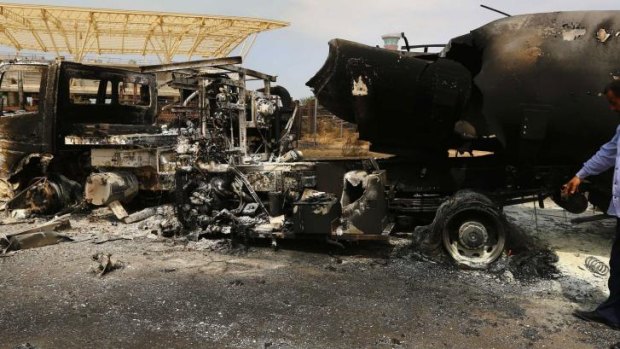 The wreckage of a truck and a plane at Tripoli International Airport.