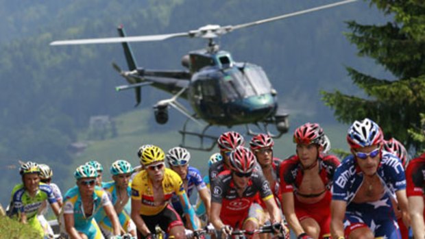 Cadel Evans (yellow jersey) struggles as the pack surges towards Colombiere pass.