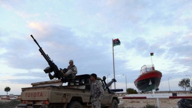 Rebels stand guard at the entrance to the Es Sider terminal in Libya, where a North Korean-flagged tanker was docked. 