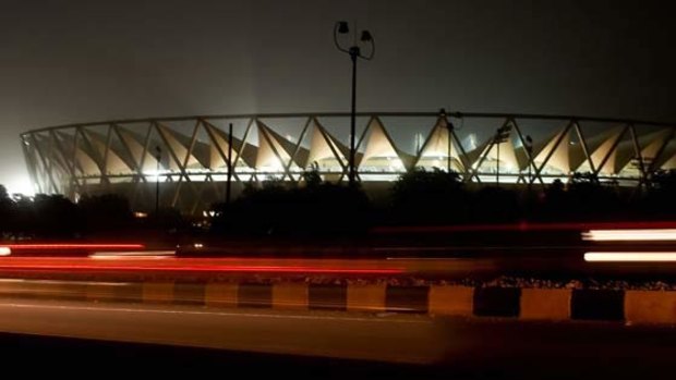 Indian construction workers work under lights at the Jawahar Lal Nehru Stadium in New Delhi.  <i>Photo: AFP/Manan Vatsyayana</i>