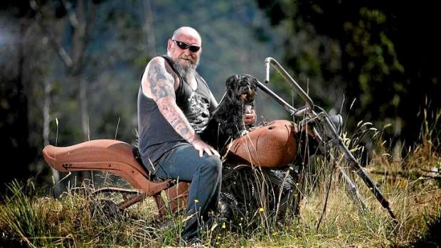 Rob Greig sits on his Harley with Missy. His house and bike were destroyed during the Black Saturday bushfires.