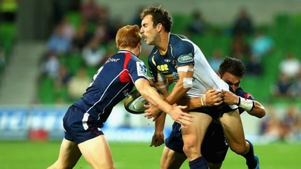 Brumbies playmaker Nic White gets smashed by the Rebels' brutal defence.