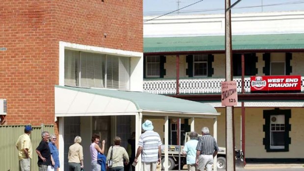 Victorian tourists inspect the bank building in Snowtown.