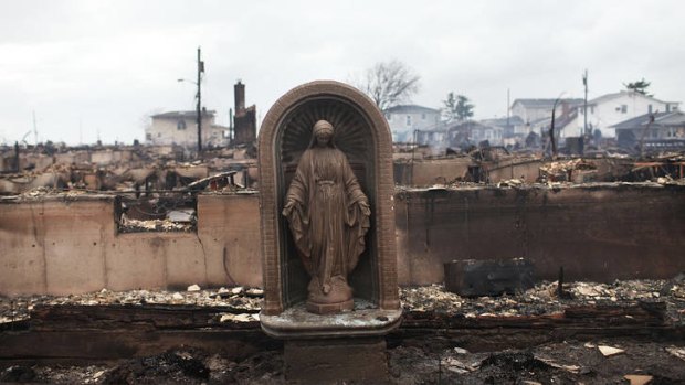 A Virgin Mary is all that remains from a home which was destroyed during superstorm Sandy in the Breezy Point neighbourhood.