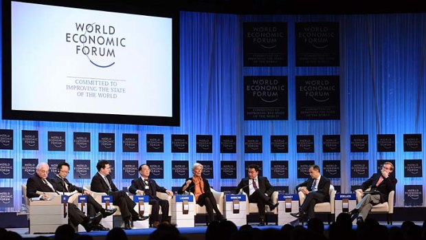 ''No one is immune. It's not just a euro zone crisis'' &#8230; IMF boss Christine Lagarde, centre, with forum participants in Davos, said European countries needed to do more to help resolve the crisis.