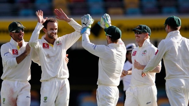 Nathan Lyon, second left, celebrates the dismissal of Jacques Rudolph during their first test cricket match at the Gabba.