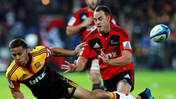 Nanai-Williams of the Chiefs passes under pressure from Israel Dagg of the Crusaders.