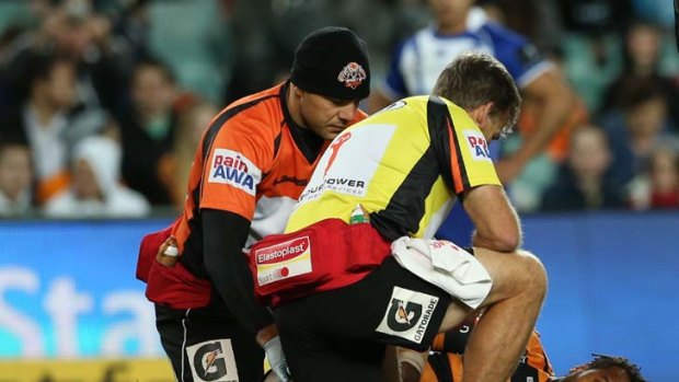 Down and out &#8230; Lote Tuqiri receives treatment on his arm.
