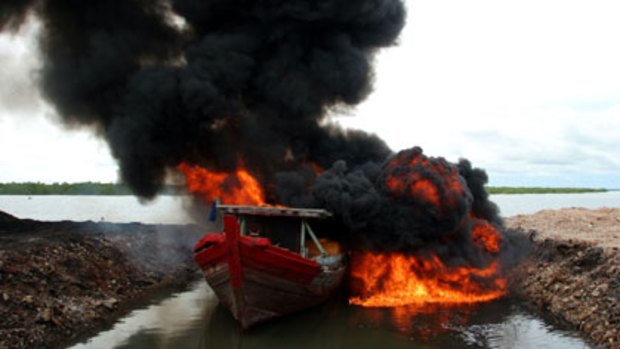 Seized Indonesian fishing vessels are burned in Darwin after being caught fishing illegally in Australian waters. 