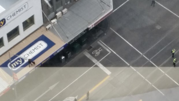 Man who has climbed Bourke St rooftop CREDIT: Reddit