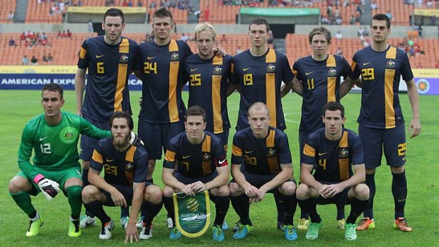 The Australian team poses before its East Asian Cup match against China.