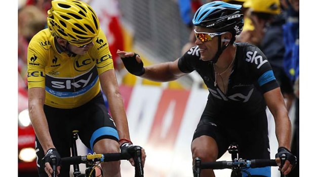 Well done: Chris Froome (left) gets a congratulatory pat from Australian teammate Richie Porte at the end of the 18th stage.