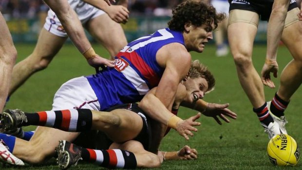 Will Minson gets a grip on Nick Riewoldt as the ball goes loose.