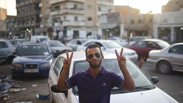 Ahmed Najer, 26, shop owner, flashes V-victory at the rebel-held town of Benghazi overnight.