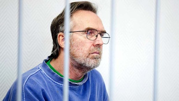The last detainee: Greenpeace activist Colin Russell behind bars during a bail hearing.