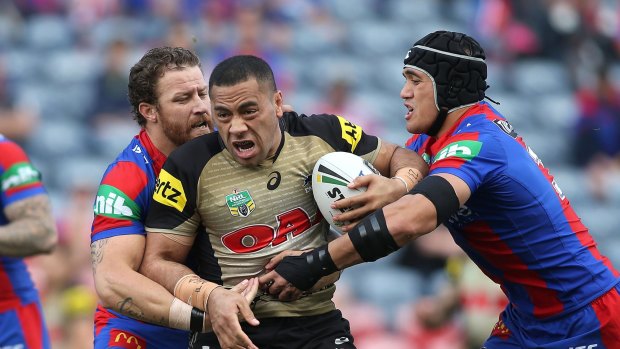 On the charge: Suaia Matagi crashes into the Newcastle defence last season for the Panthers.