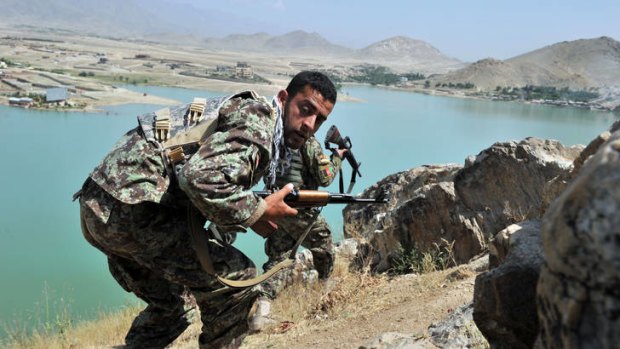 Afghan National Army soldiers take positions on a hill on the outskirts of Kabul after a Taliban attack, June 22.