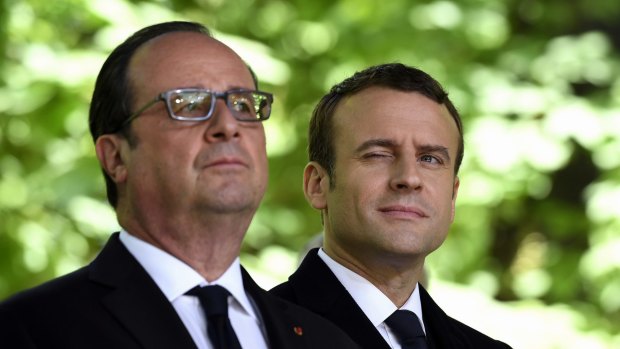 French President-elect Emmanuel Macron, right, and outgoing President Francois Hollande mark the anniversary of the abolition of slavery in Paris on Wednesday.