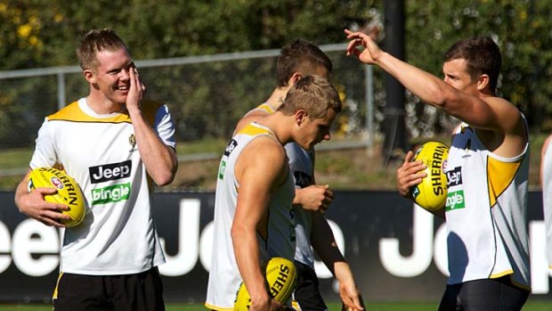 Playful Tigers: Jack Riewoldt enjoys a joke with teammates at training yesterday.