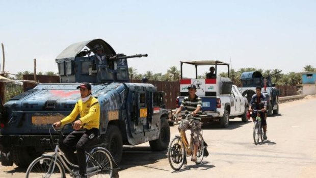 Baghdad belt: Iraqi police patrol in the town of Taji, about 20 kilometres north of the capital. 