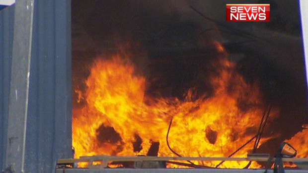 Fire burns inside a boat shed south of Brisbane.