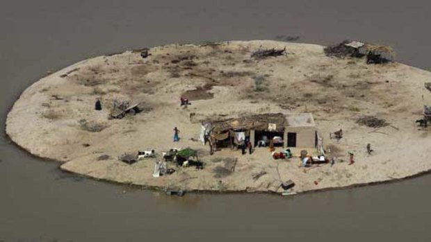 A family is trapped by flood waters near Bachel in Sindh Province, southern Pakistan. Aid agencies fear that cannot afford to offer even basic help. <i>Picture: AP</i>